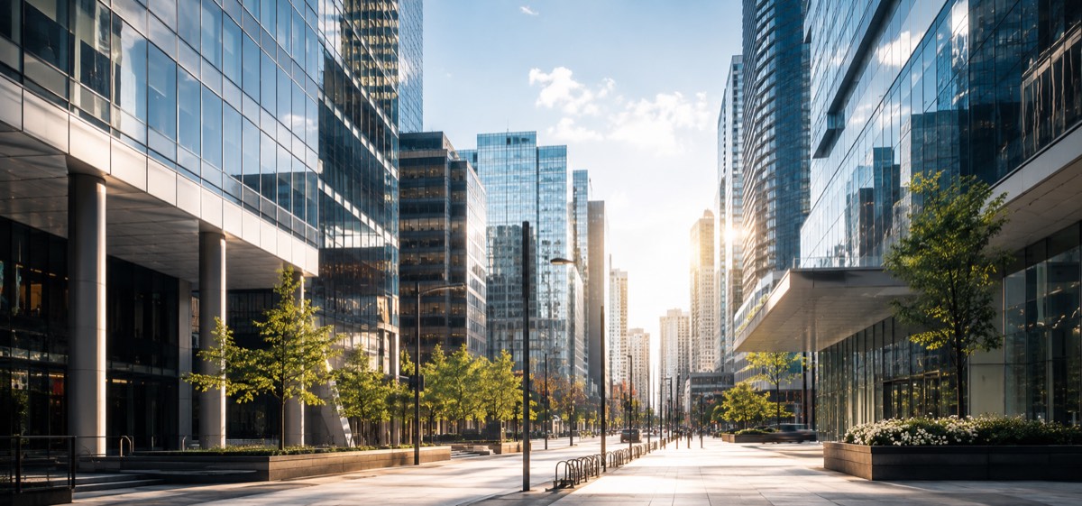A financial district at midday — glass office towers lining a quiet street.